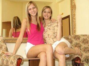 Blonde teens Katrina and Laura expose their underwear in white skirts on picsofsex.com