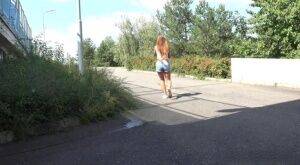 White girl Lucka pulls down jeans shorts for a pee on the side of a road on picsofsex.com