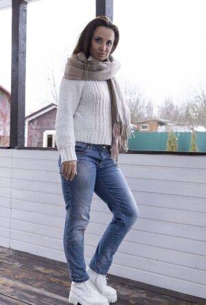 Kamilla is outside in the cold in her white sweater and denim jeans She enjoys on picsofsex.com