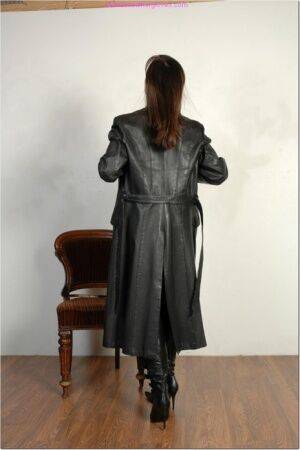 Brunette female dons long leather coat in leather boots and stockings on picsofsex.com