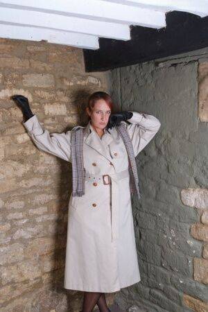 Redhead woman Sammy frees her small tits from trench coat in leather gloves on picsofsex.com