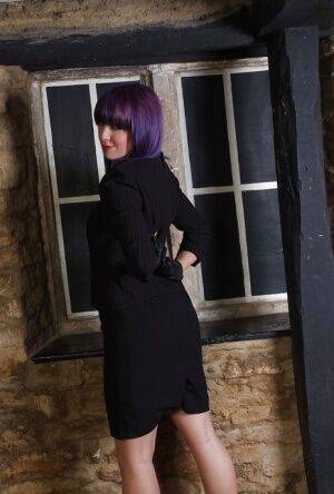 Pretty chick with purple hair poses fully clothed in black dress and pumps on picsofsex.com