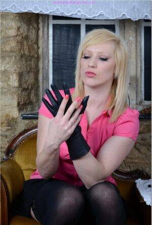 Natural blonde Axajay slides panties aside after donning leather gloves on picsofsex.com