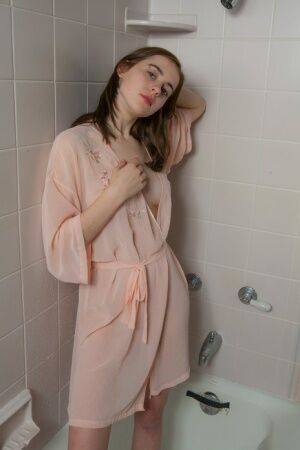 Cute young teen Eva Green petting her wet bald pussy in the shower on picsofsex.com