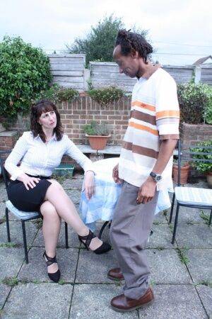 Cheating UK housewife seduces a black man in a black skirt on patio - Britain on picsofsex.com