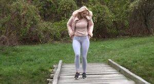 Blonde Katy Sky shows her bald beaver while squatting outside for a pee on picsofsex.com