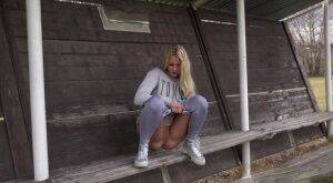Blonde Katy Sky pisses next to a football field on picsofsex.com