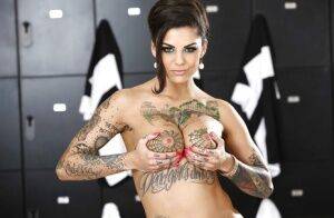 Tattooed brunette Bonnie Rotten is teasing her big tits on camera on picsofsex.com