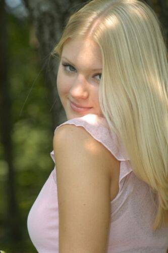 Charming blonde teen Tiffany hikes skirt over cotton panties in the forest on picsofsex.com