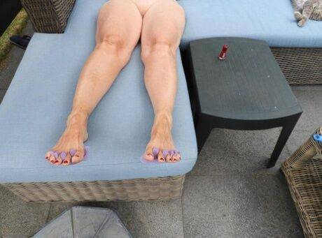 Old woman Kat Kitty gets naked on outdoor sofa while painting her toenails on picsofsex.com