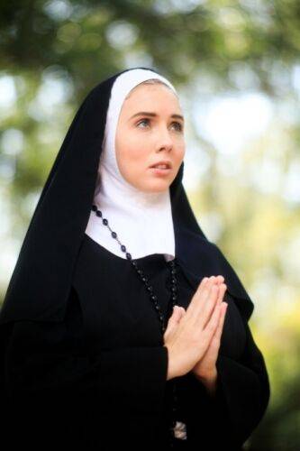 Thick Nun exposes herself in the courtyard wearing over the knee socks on picsofsex.com