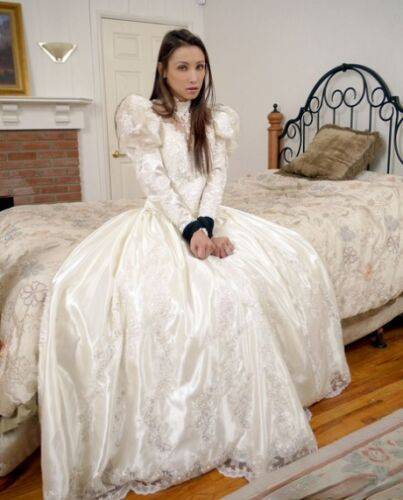 Brunette bride Celeste Star is ballgagged and tied up in her wedding dress on picsofsex.com