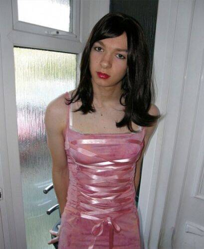 Petite TGirl showing off that slender body of hers in a pink dress on picsofsex.com