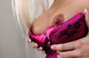 Lingerie model Maria is demonstrating her big tits in close up on picsofsex.com