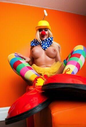 Hot cosplay MILF Leya Falcon in clown costume fondling her huge big tits on picsofsex.com