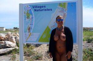 Mature fatty Chrissy walks by the sea with her round big tits bared on picsofsex.com