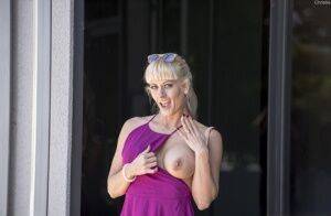 Naughty blonde flashes no panty upskirts and her big tits out in public on picsofsex.com