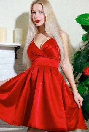 Nice blonde teen Genevieve Gandi removes red dress to display her trimmed muff on picsofsex.com