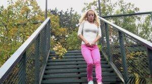 Blonde Victoria Pure pulling down her tight pants to pee on the bleachers on picsofsex.com