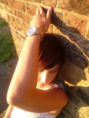 Girl next-door type Roxy shows off her new watch while outside her home on picsofsex.com