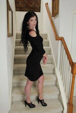 Clothed milf beauty Veronica Stewart is taking off her black dress on picsofsex.com