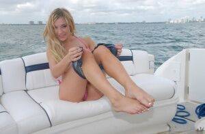 Lusty blonde Amy Brooke strips bikini and rubs pussy on the boat on picsofsex.com