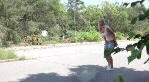 Blonde female Nikki Dream can't hold her pee any longer and squats on roadway on picsofsex.com