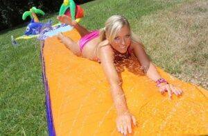 Young blonde Ally Kay ends a water fight by having sex in backyard on picsofsex.com