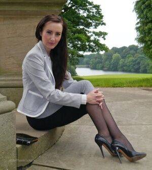 Clothed woman Sophia descends park steps in a long skirt and stiletto heels on picsofsex.com