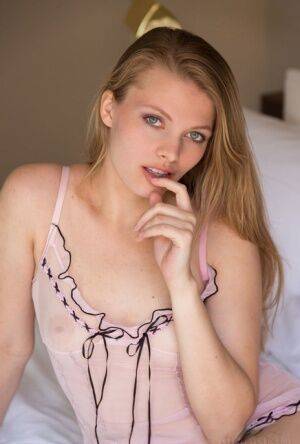 Nice teen Sophie Sparks sheds sheer lingerie to model naked on her bed on picsofsex.com