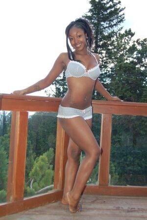 Black girl Amber uncups her big tits while getting in an outdoor hot tub on picsofsex.com