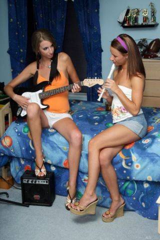 Sexy girls play some music and fuck with a huge strapon dildo on picsofsex.com