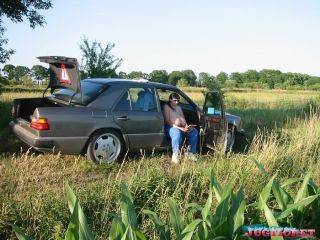 Mature plumper showing her big boobs in the car outdoors on picsofsex.com