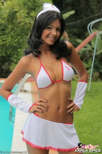 Swarthy Latina Karla Spice In White Uniform And Bikini Teasingly Poses By The Pool on picsofsex.com