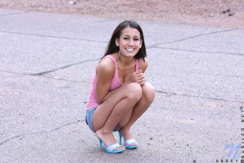 Frisky Teen Chic Amia Moretti Pulls Down Her Blue Shorts And Pink Panties Outdoors on picsofsex.com