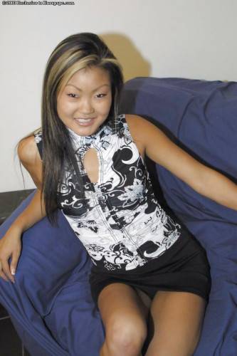 Hot asian teen Lucylee in nice skirt exhibits small tits and shaved pussy on picsofsex.com