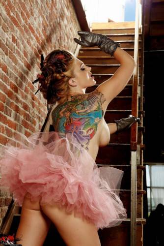 Tattooed Redhead With Big Boobs And Long Legs Jesse Capelli Poses On The Stairs on picsofsex.com