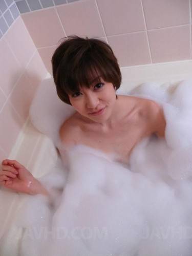 Short Haired Asian Honey Akina Hara Snacks On Her Boyfriend's Hairy Cock During A Bath. on picsofsex.com