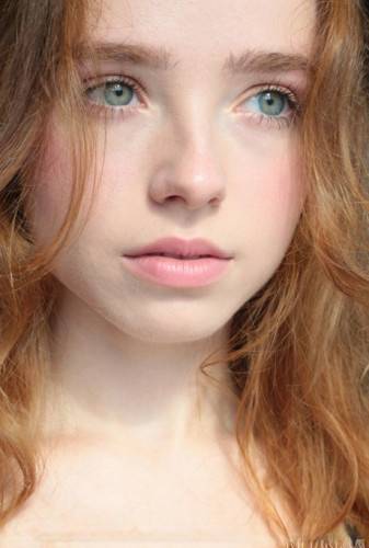 Young redhead Rinna Ly slips off black lingerie in a tempting fashion on picsofsex.com