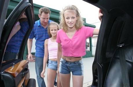 Lusty teenies give a proper sandwich blowjob on the back seat on picsofsex.com