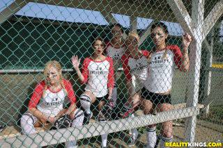 Several busty softball-playing hotties end up strap-on fucking each on picsofsex.com