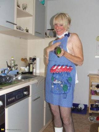 Naughty housewife gets frisky in the kitchen on picsofsex.com