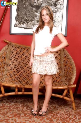 Stunning teen Fiona Rossi in sexy skirt unveiling tiny tits and spreading her legs on picsofsex.com