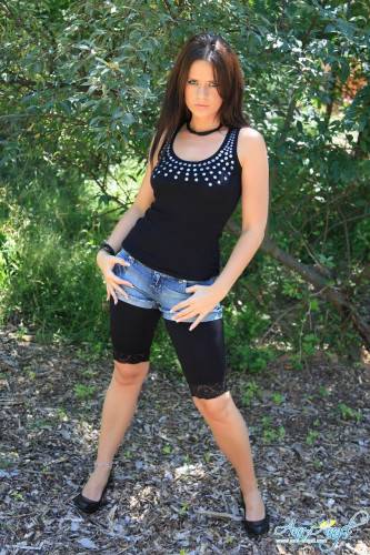 Alluring Brunette Ann Angel In Ultra Stylish Black Denim Shorts Poses In Nature on picsofsex.com