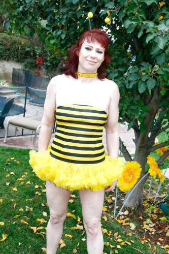 Hot red-haired mature Dirty Garden Girl in fancy skirt exhibiting her ass and jerking off outside on picsofsex.com