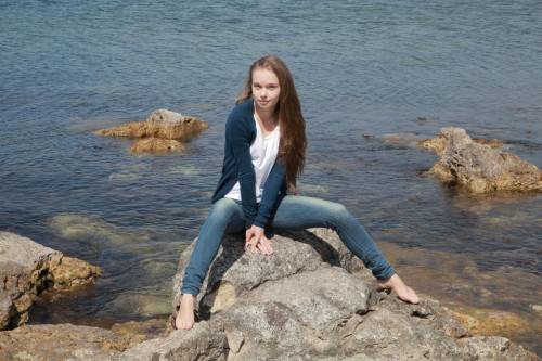 Gracile blonde teen Milena D in jeans exhibits small tits and butt on the beach on picsofsex.com