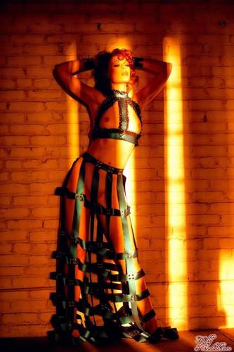 Redhead Justine Joli In Amazing Dress Made Of Leather Belts Poses In The Empty Room on picsofsex.com